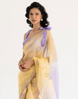 Woman wearing a yellow and lavender pure silk organza saree with check lavender blouse
